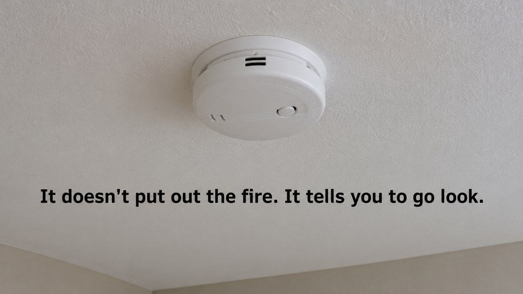 A ceiling smoke alarm: it does not put out the fire, it tells you to go look